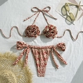 Detailed flat lay of red leopard print bikini featuring 3D floral accents and side ties - S / Red