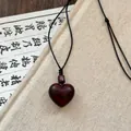 Macro detail of heart-shaped dark red wood pendant with silver cloud pattern bead - Red Wood Texture Heart Pendant / Black-Dark Brown Rope (Heart Style)