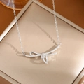 Polished silver titanium steel bow necklace featuring sparkling micro-pave crystals - A0123 Silver Ribbon Knot