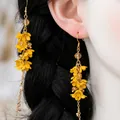 Detail of yellow flower tassel earrings with matte petals and long metal chains - Ear Hook - Gold - Yellow - Painted Flower