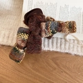 Macro shot of tweed bow hair claw clip with antique gold wire and resin base - Brown Tweed Bow Hair Claw