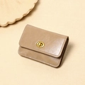 Close-up of tan leather wallet featuring a golden twist lock and precise stitching details - Khaki
