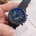 Men's fashion watch with blue dial, golden indices and black silicone strap held in hand - Black