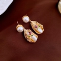 Detailed close-up of Baroque pearl earrings with purple enamel rose on velvet background - Golden Bouquet Pearl Drop Earrings (HE20922-2)