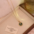Detail of vintage gold rose pendant with deep cyan enamel and elegant white pearl - Green