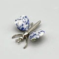 Lapis lazuli butterfly brooch with heart-shaped stone wings and silver metal body - Blue Spot Stone