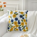 Square cotton linen pillow cover with yellow and blue tulip embroidery on a white sofa - String of Fortune Flowers (Cover Only)