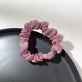 Detail showing the glossy texture and pleated design of the pink satin scrunchie accessory - Pink