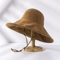 Detail of wide brim canvas sun hat in tan with adjustable chin strap on wooden stand - M(56-58cm) / Upgraded Caramel (21I021)