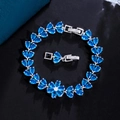 Detailed close-up of blue zircon flower bracelet with tear-drop cut crystals on black texture - Sky Blue