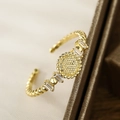 Adjustable 18K gold plated bangle with sunburst emblem and rectangular zircons - Sun Radiance Style