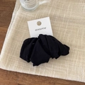 Elastic black fabric scrunchie on white display card for daily ponytail styling - Versatile Black 4-Pack