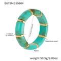 Macro detail of elastic resin bracelet featuring marble green blocks and gold steel rings - 55mm / Blue