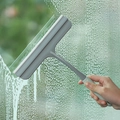 Non-slip grey silicone window squeegee cleaning a water-covered glass surface - Model 077 / Blue