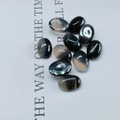 Macro detail of polished oval black agate stone cabochon with natural grey veins - 6*8mm / Black Agate