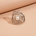 Macro shot of silver irregular layered lines on a textured ring with white pearl detail - Silver
