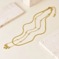 Elegante collana a doppio strato dorata con ciondolo a fiocco e perline in metallo - Collana a doppio strato