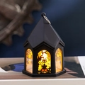 Detail of a black Halloween lantern with glowing orange cat and pumpkin cutouts - Night Cat