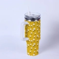 Detail of 40oz yellow stainless steel tumbler with white floral patterns and handle - Small Floral/Yellow