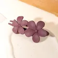 Detailed view of two matte purple flower hair clips on a white ceramic display tray - Double Flower Clip - Matte Bean Paste Purple
