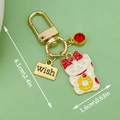 Golden Maneki Neko lucky cat keychain with red gemstone and wish charm detail - Fortune Cat