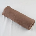 Detailed texture of brown cotton linen scarf with wrinkled fabric and fringe edges - Khaki