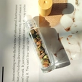 Glass roller bottle with assorted colorful natural crystal stones and a wooden cap - Unakite