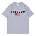 Grey cotton T-shirt featuring FREEDOM text and American flag print in a flat lay view - Gray