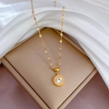 Detailed view of a gold Roman numeral necklace with a clear zircon stone in a jewelry box - Gold