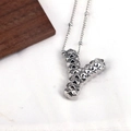 Macro shot of a silver letter Y pendant necklace featuring a unique textured 3D geometric surface - Letter Y