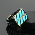 Macro detail of titanium steel ring with colorful geometric texture and iridescent finish - Rainbow