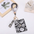 Detail of snake pattern card holder with wooden beads wristlet and leather tassel - Black White Snake Pattern