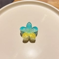Macro shot of gradient blue and yellow plumeria hair claw with subtle glitter finish - Colorful Plumeria Blue Yellow