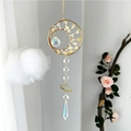 Detail of sun catcher with golden crescent moon, yellow crystals and iridescent prism - Citrine