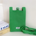 Detailed close-up of green knitted phone bag with silver snap and Stannum label - Dark Green