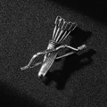 Close-up of vintage silver bow and arrow quiver brooch with black stones on black background - Ancient Silver Bow & Arrow