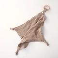 Detail of khaki cotton muslin baby comforter featuring a natural wooden teething ring and knot - Dark Coffee