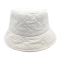 Detailed view of white corduroy bucket hat with heart quilted texture and warm fabric - White