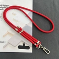 Detail of red 8mm adjustable crossbody phone lanyard with silver metal clip and black patch - 8mm Dual Adjustable / Red