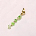 Detailed view of a gold textured ear clip with natural green stone drop pendant on white background - Light Green Short