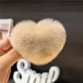 Detail of a beige heart-shaped faux fur hair clip showing soft plush texture and craft - Milk Tea