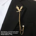 Detail of gold eagle brooch with zircon and tassel chains on black suit lapel - Golden Eagle Zirconia Style (TL24025)