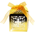 Macro shot of gold laser-cut cross candy box with shiny metallic finish and ribbon bow - Reflective Gold