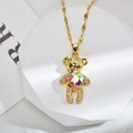 Golden teddy bear necklace with heart-shaped gemstone and shimmering zircon inlay - Colorful