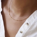 Minimalist gold titanium steel bead chain necklace shown on a model's collarbone - Bead Curb Chain / Gold