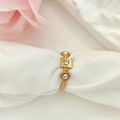 Macro shot of gold vintage textured ring with three clear crystals on white silk - Adjustable Open / Gold White Zirconia