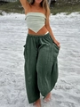 Detail of dark green wide-leg trousers with large side pockets and drawstring waist design - S / Green