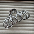 Macro detail of silver plated metal hair claw clip with spiral geometric design - Loop Ring Silver 13cm