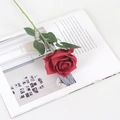 Realistic red velvet artificial rose with green leaves on an open book for home decor - Silk Wine Red