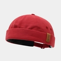 Detail of red canvas brimless docker hat showing the brown label and black lining - Adjustable / Burgundy